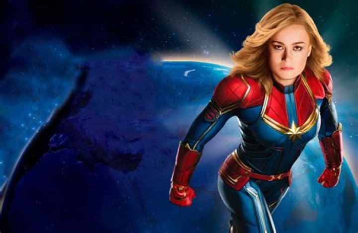 Brie Larson flying in space with cosmic colors surrounding her in 'The Marvels'