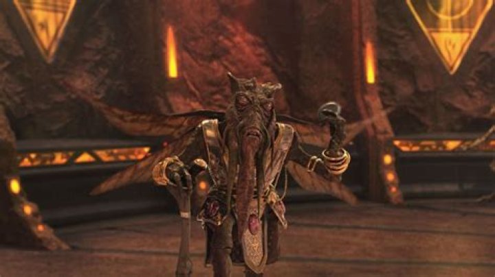 Poggle the Lessler is standing and holding his arm up.